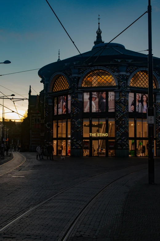 an image of a beautiful building with some people walking around