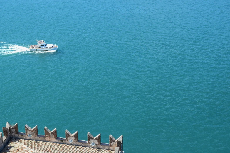 two boats that are on some water near a building