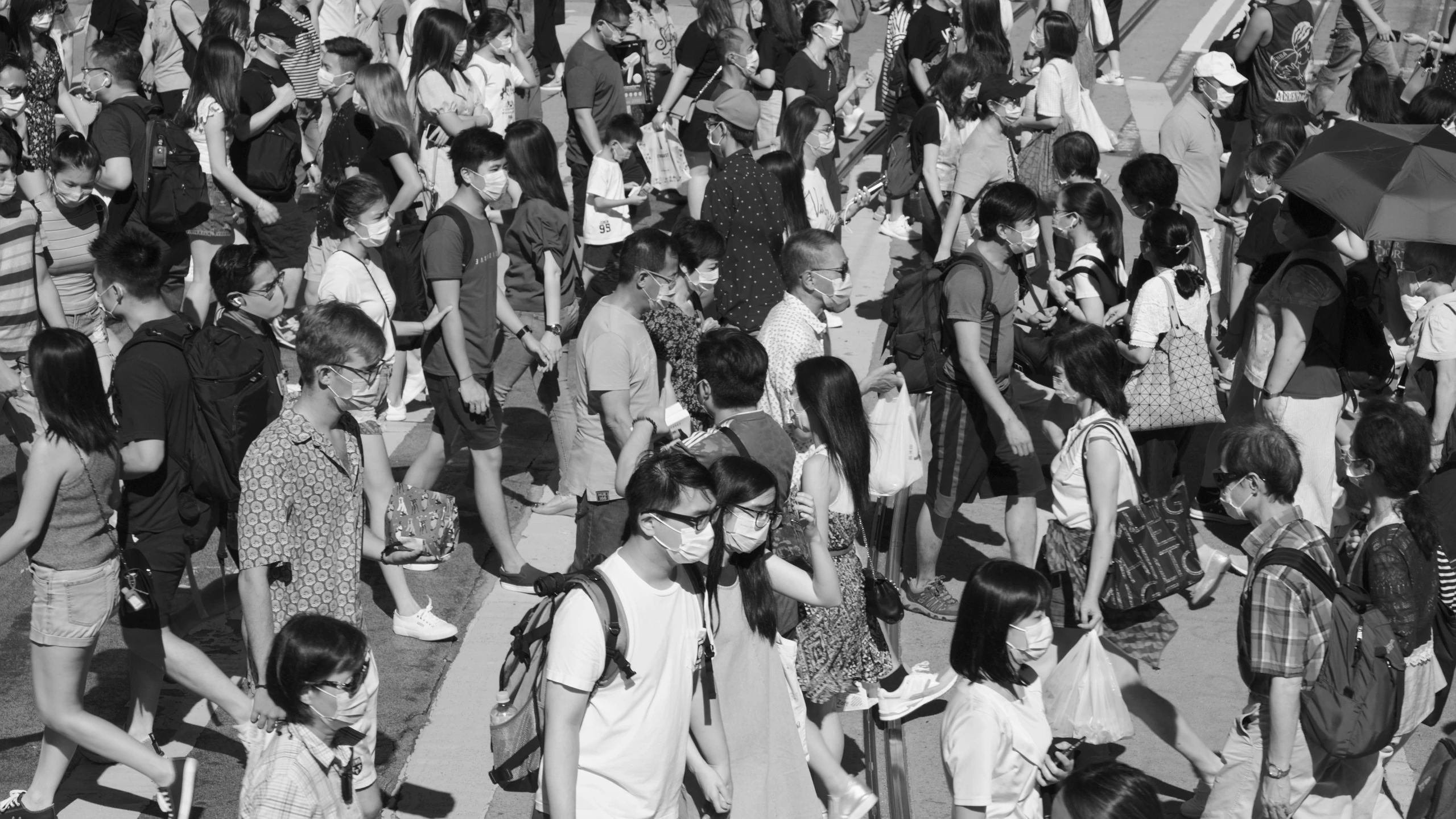 a crowd of people walk together in a crowd