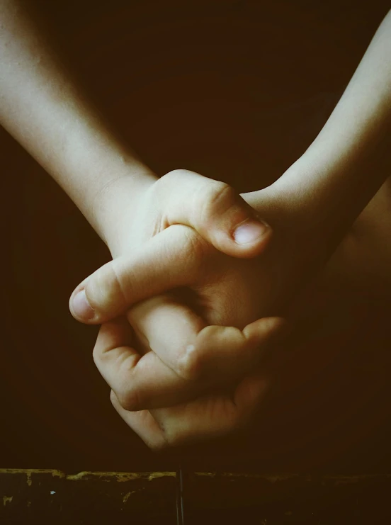 a close up image of two people holding hands