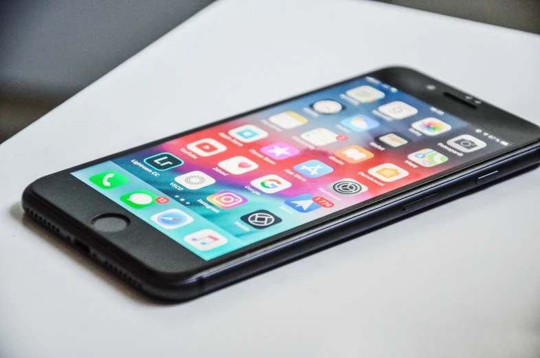 an iphone sitting on a table looking at the display