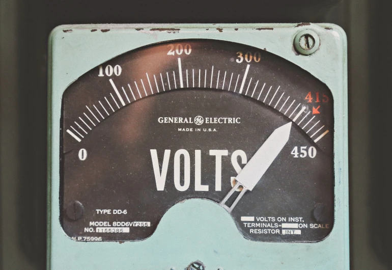 volts meter is shown showing the time on each side of the meter