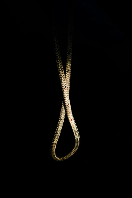 a large long white string on top of a black wall