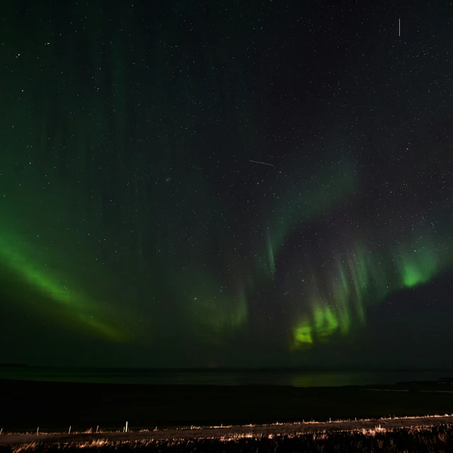 several aurora bores appear over the horizon of an airport