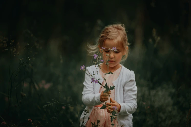 a  with pink flowers around her hands