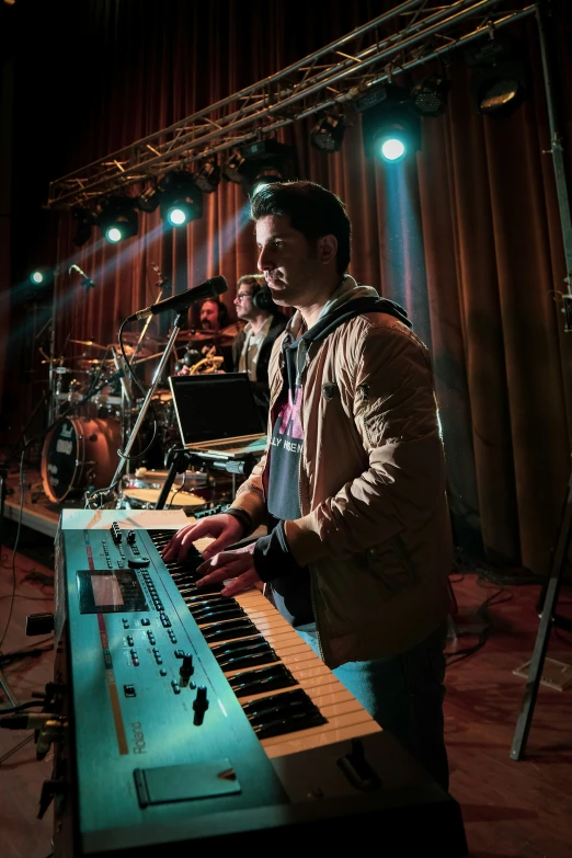 two men standing next to a sound equipment set up