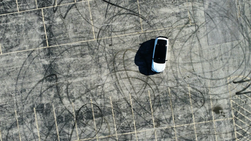 an aerial view of an old car sitting in the middle of nowhere