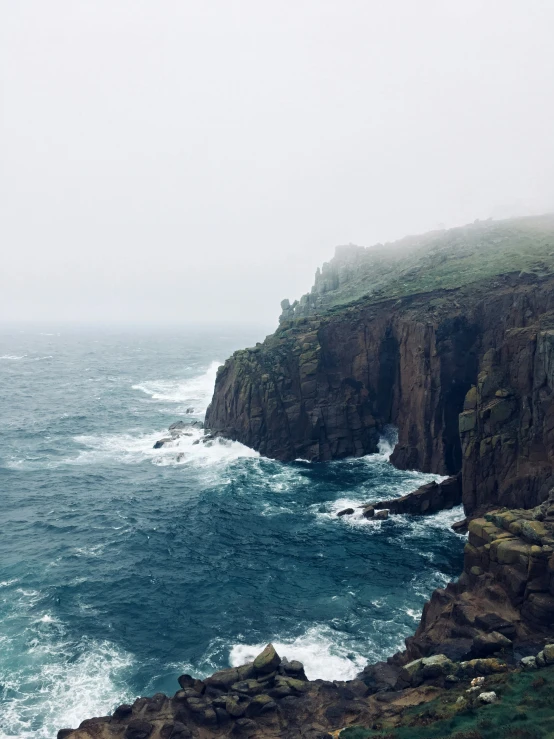 a rock cliff over looking a body of water