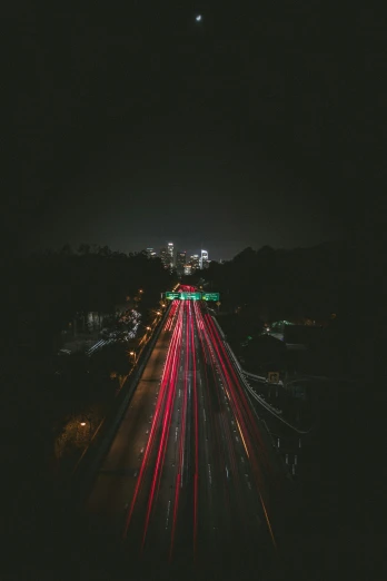 a long exposure s taken at night shows traffic lights on the highway