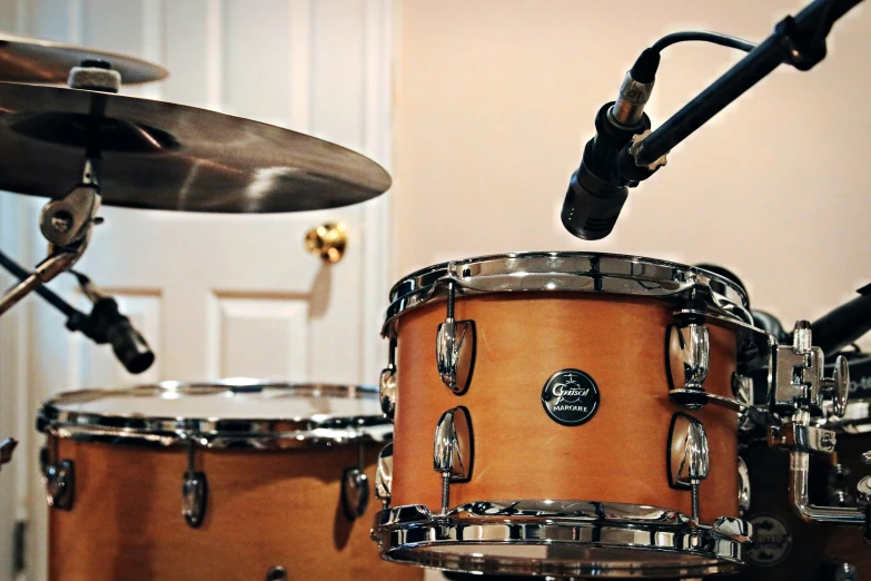 drums, sticks and cy - e stand in front of a door