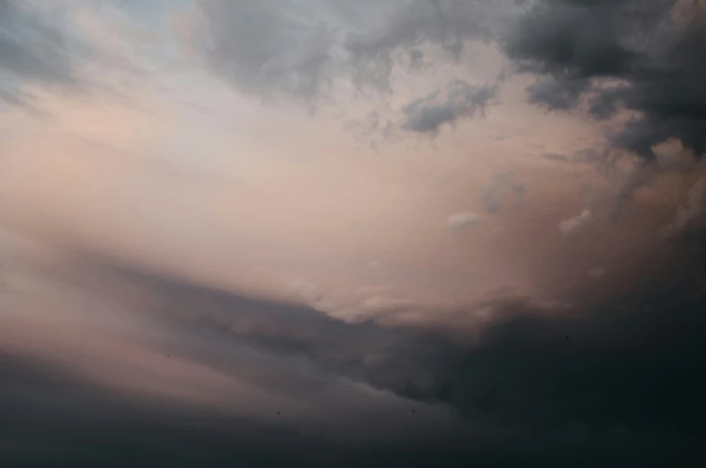 a boat in the ocean with clouds in the background