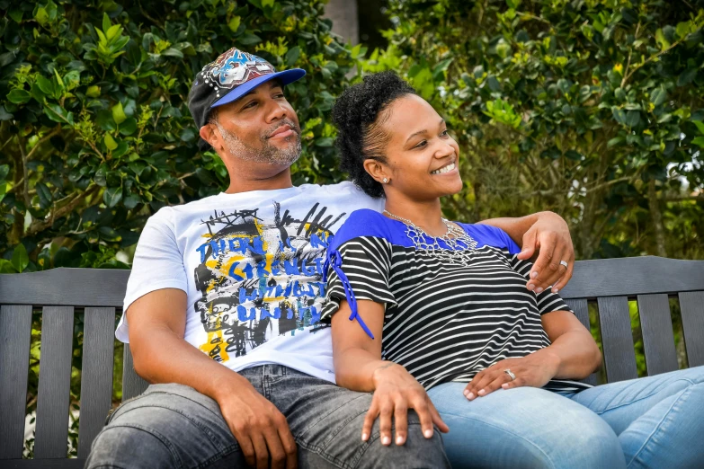 man and woman sitting on bench next to each other