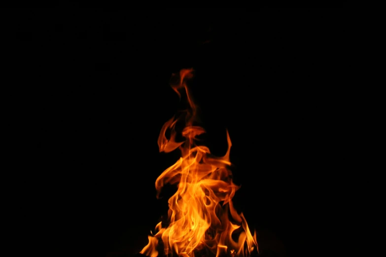 fire flames burning in the dark against a black background