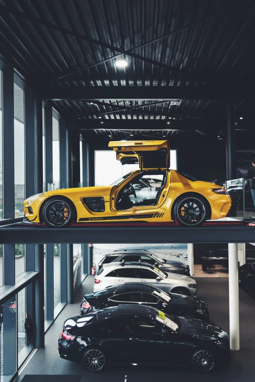 the yellow sports car is parked in the garage