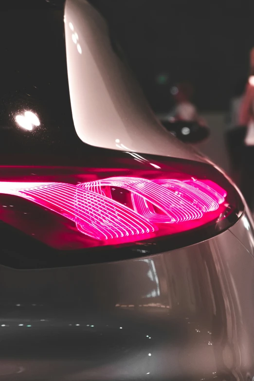 the taillight of a silver sports car