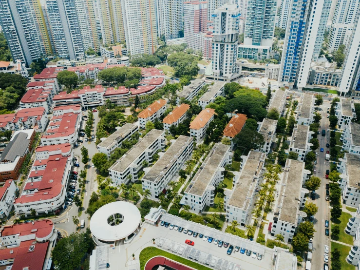 a large aerial view of several building complex in the foreground and on to other buildings with red roofs