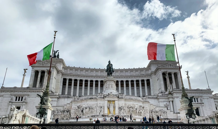 an italian and english flag in front of a palace