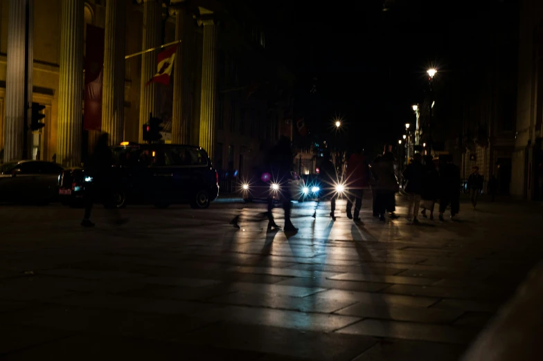 the street is crowded with pedestrians and vehicles at night