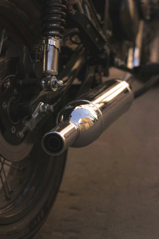 a motorcycle's exhaust pipe is seen with a closeup