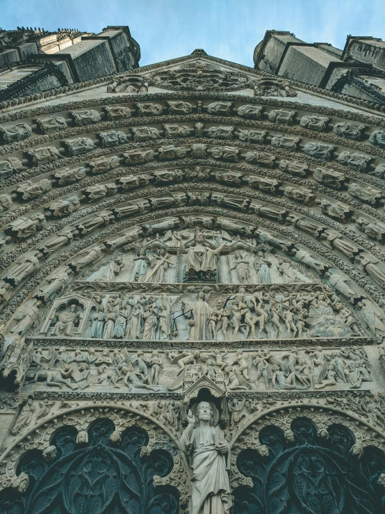 an ornate archway over looking the statues of people