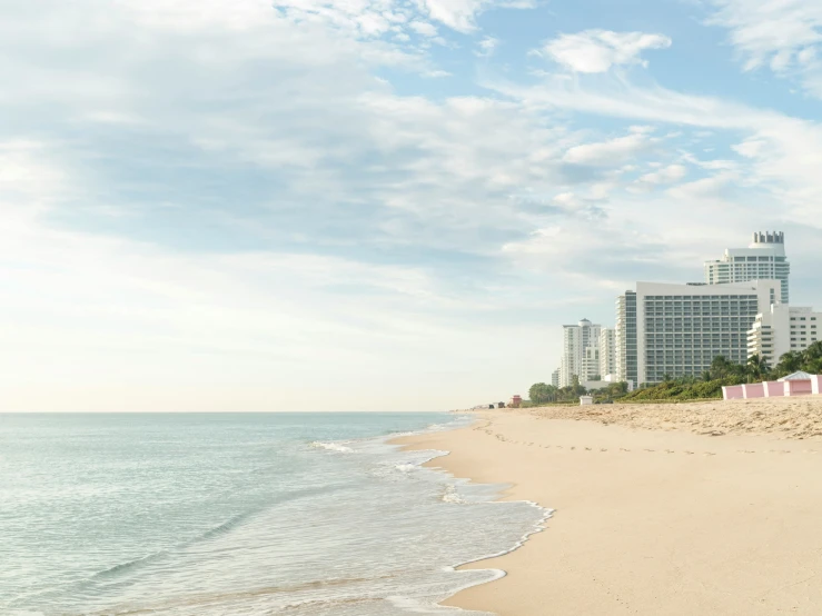 a city is visible from the ocean on the beach