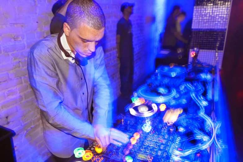 a man wearing a suit stands at a table in front of a computer