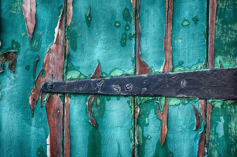 green painted building with an old knife sticking out of the wall