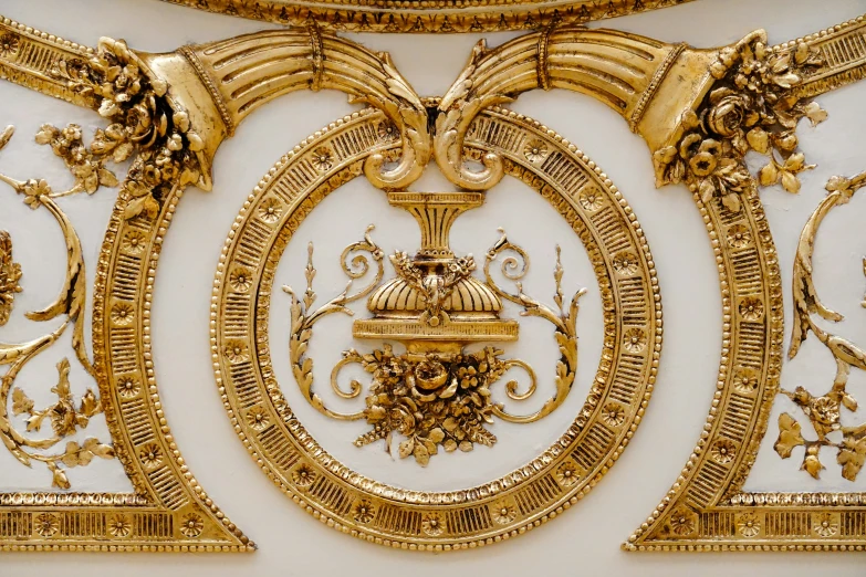 a wall with a fancy gold decoration on it