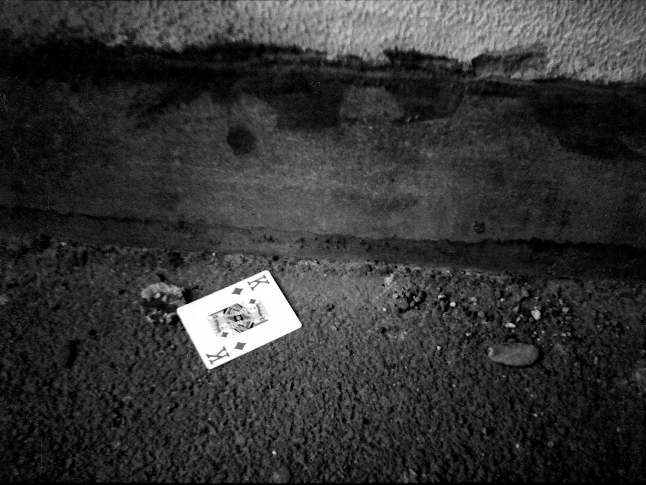 some cards laying on the ground on top of a cement