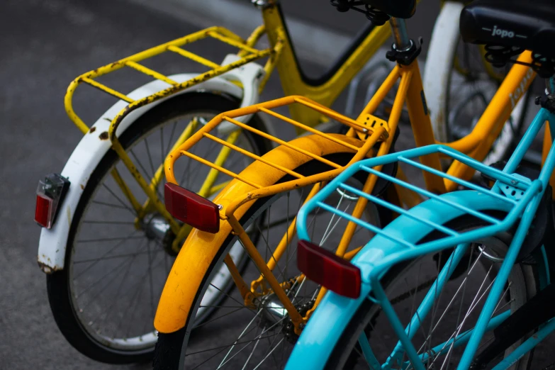 two different colored bicycles are parked on a street