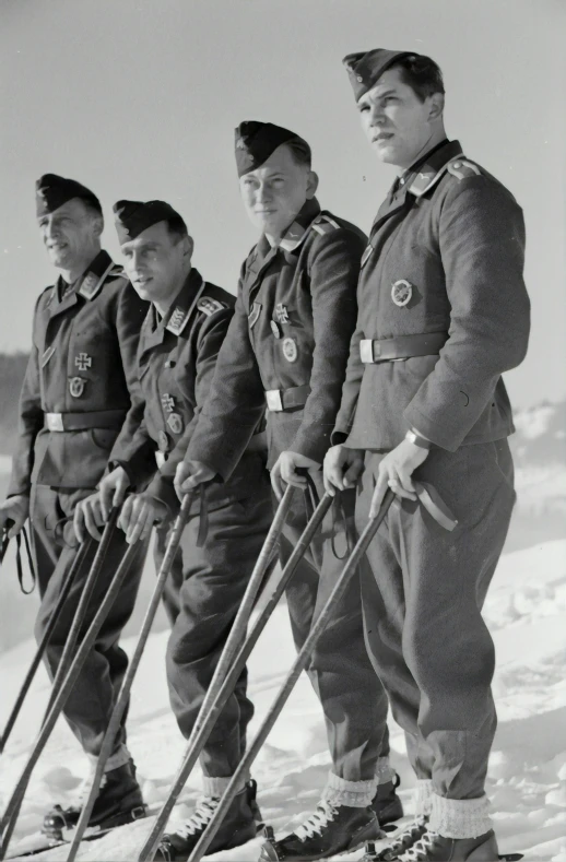 a black and white po of skiers lined up for a picture