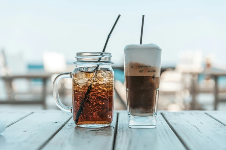 two cups filled with drinks sit next to each other