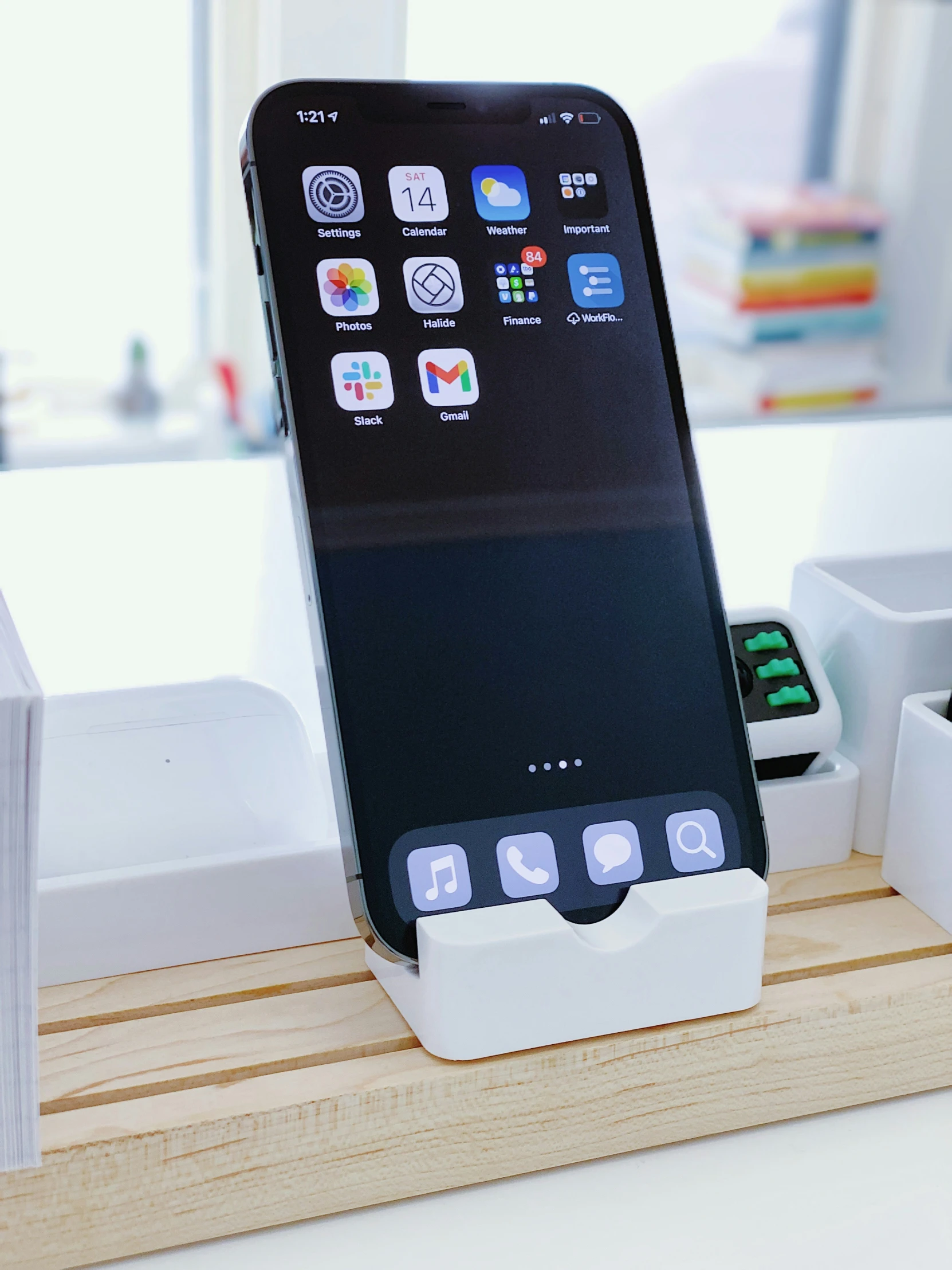 an iphone charging dock holds a card reader and other accessories