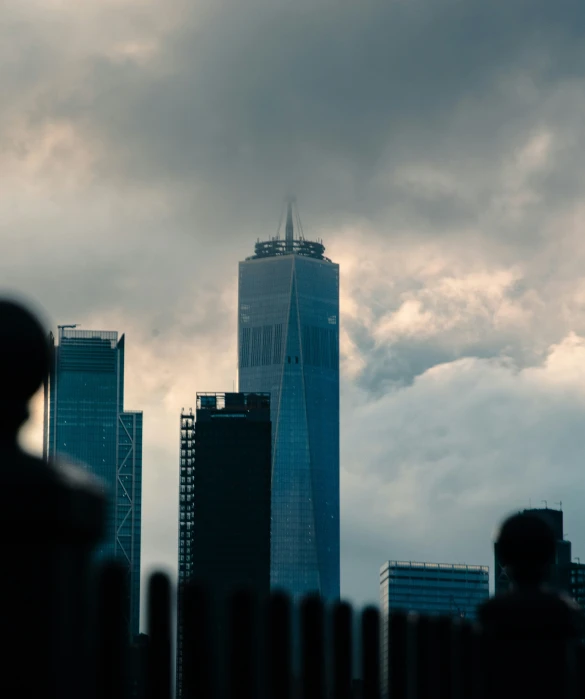 several skyscrs rise in the city during a cloudy day