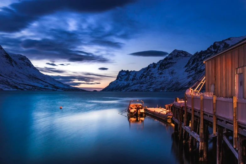 a large boat tied to a dock at night