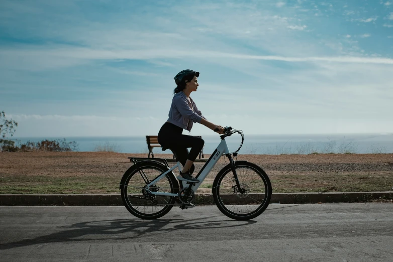 a girl riding a bike down the street