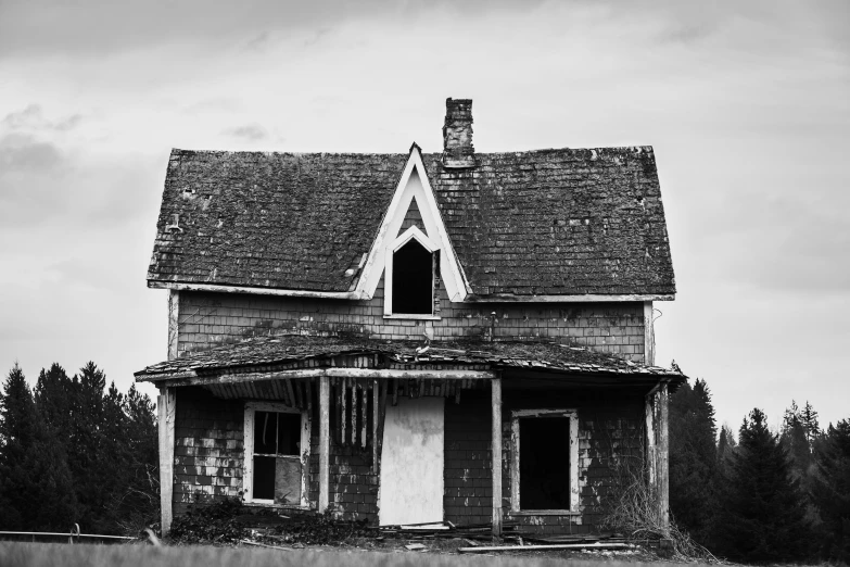 an abandoned house with a large windows and roof