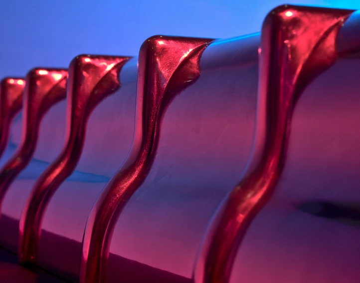 a group of pink metal seats on a red table