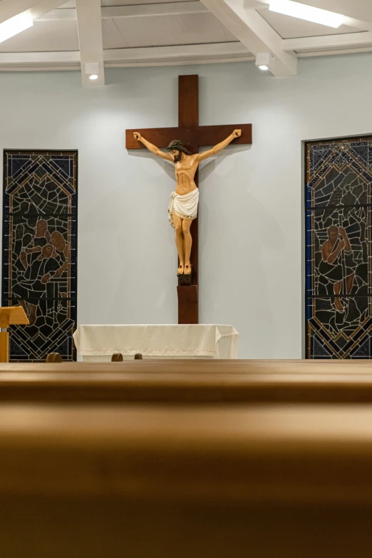 a po of the inside of a church where a crucifix hangs