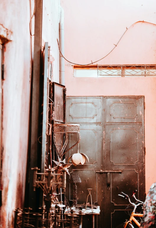 a bicycle parked by a door in an alley