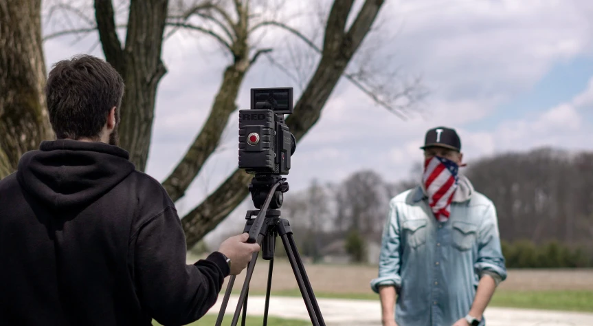 two people are shown with an old - fashioned camera set up in front of them