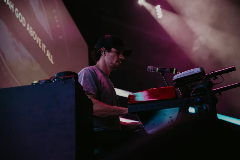 a man is playing on electronic keyboards at an event