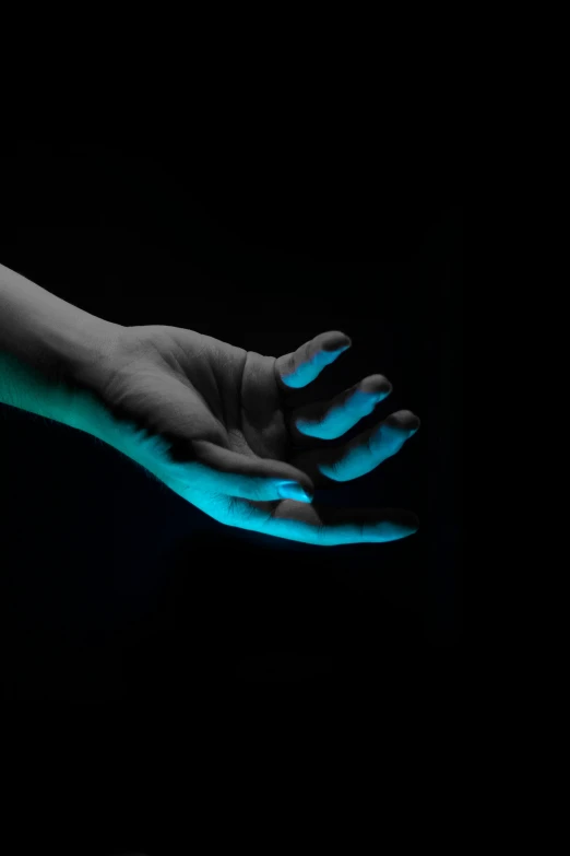 a hand holding soing that is glowing in the dark