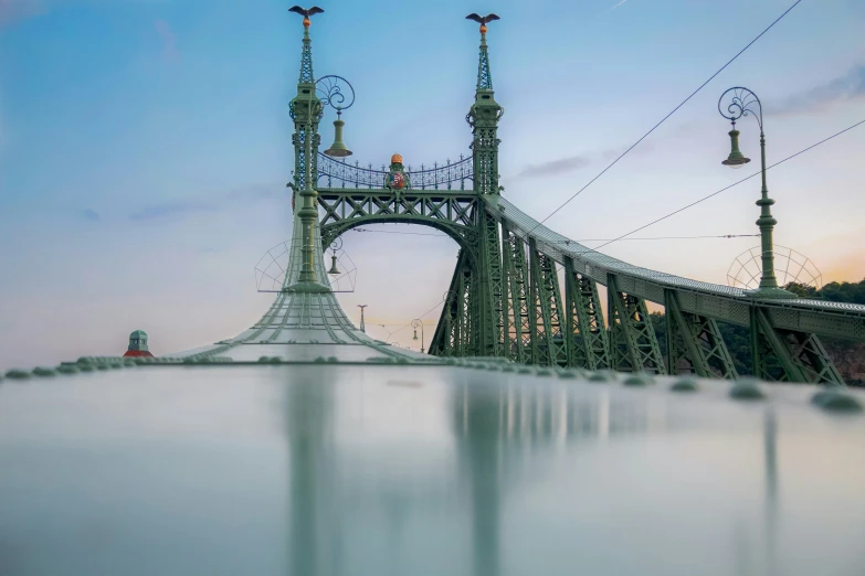 the green bridge has metal rails and lights