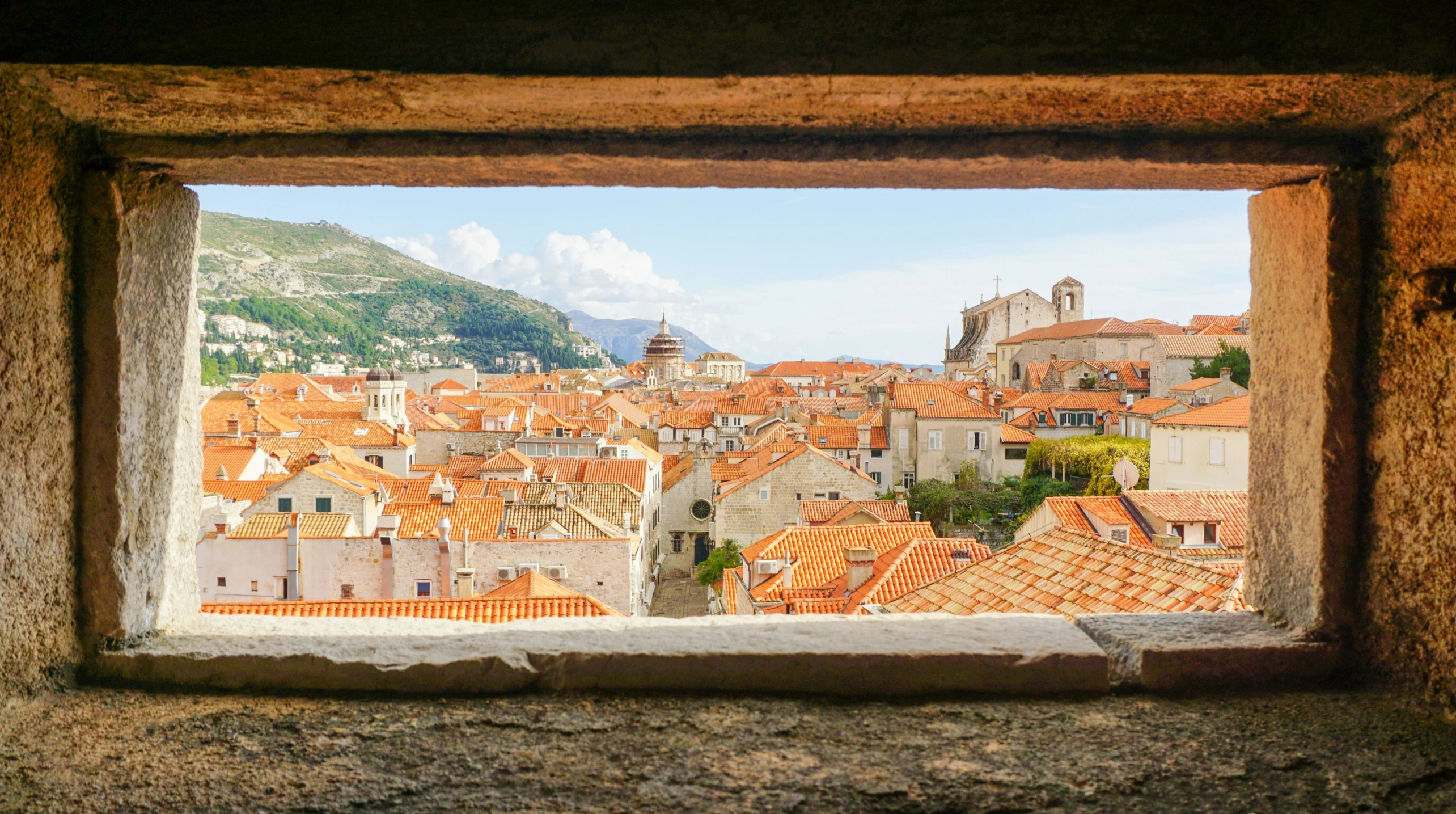 a window looking down at an urban area