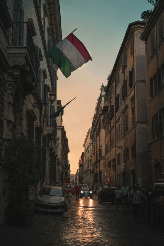 a small kite flying in the air above a street