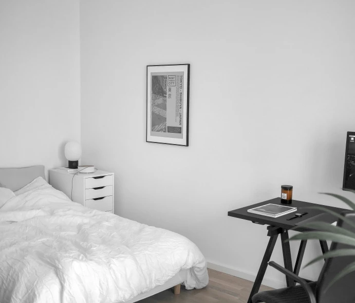 a black and white image of a small bedroom