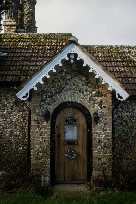 an old brick building has a small wooden door