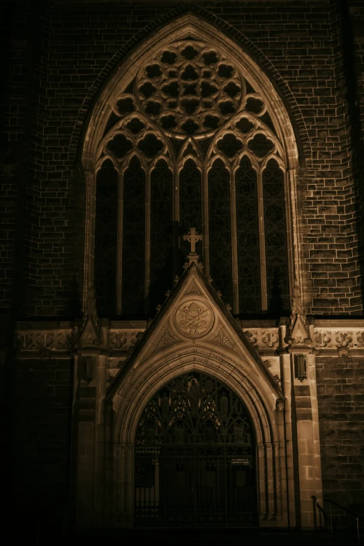 a church entrance with a large stained glass window