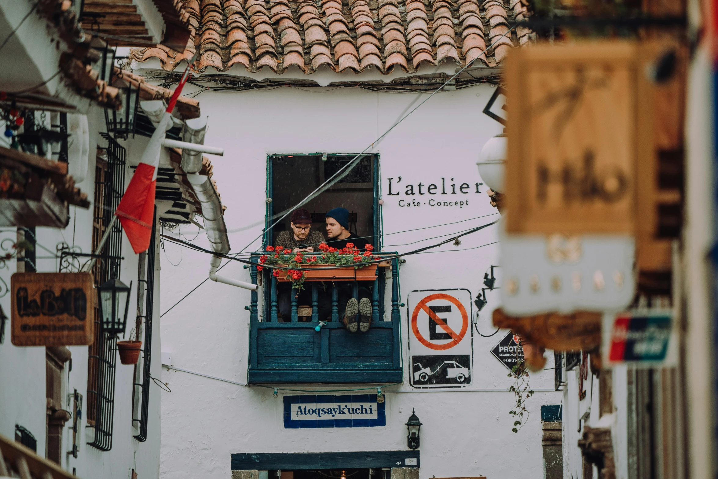 people look out the window of a white building with colorful windows